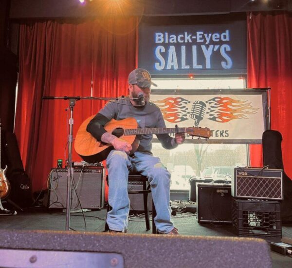 man playing guitar at music matters event