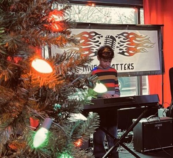 boy playing keyboard at music matters event