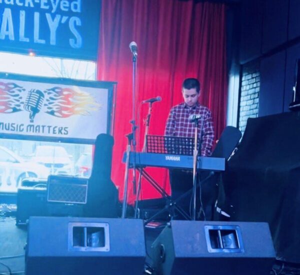 boy playing keyboard at music matters event